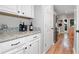 Convenient butler's pantry with granite countertops and stainless steel appliances for easy meal prep and storage at 2009 Westside Ln, Woodstock, GA 30189