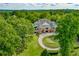 Clubhouse exterior with circular driveway, manicured lawn, and surrounded by mature trees at 2009 Westside Ln, Woodstock, GA 30189