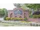 Inviting community entrance sign with brick facade, manicured landscaping, and decorative plantings at 2009 Westside Ln, Woodstock, GA 30189