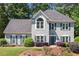 Charming two-story traditional home with a well-manicured lawn and beautiful landscaping at 2009 Westside Ln, Woodstock, GA 30189