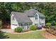 Two-story home featuring a gray facade, attached garage, and colorful landscaped yard at 2009 Westside Ln, Woodstock, GA 30189