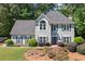 Attractive two-story home featuring a gray facade, black shutters, and mature landscaping at 2009 Westside Ln, Woodstock, GA 30189