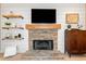 Cozy stone fireplace with shiplap accents and custom shelving at 2009 Westside Ln, Woodstock, GA 30189
