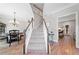 Inviting foyer features hardwood floors, stairs to the second level, and an open view to the dining and living spaces at 2009 Westside Ln, Woodstock, GA 30189
