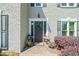 Elegant front door with a wreath, surrounded by potted flowers and well-kept landscaping at 2009 Westside Ln, Woodstock, GA 30189
