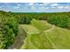 Scenic aerial view of a well-maintained golf course with lush green fairways and surrounding trees at 2009 Westside Ln, Woodstock, GA 30189