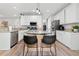 Bright kitchen features a center island with seating, stainless steel appliances, and ample cabinet space at 2009 Westside Ln, Woodstock, GA 30189