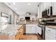 Open kitchen featuring granite countertops, stainless steel appliances, and hardwood floors, perfect for entertaining at 2009 Westside Ln, Woodstock, GA 30189
