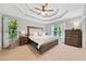 Luxurious main bedroom featuring a tray ceiling, neutral tones, and ample natural light at 2009 Westside Ln, Woodstock, GA 30189