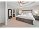 Elegant primary suite features a king bed, large mirror, and a glimpse of the attached bathroom at 2009 Westside Ln, Woodstock, GA 30189