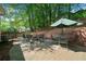 Outdoor patio with brick pavers, seating around a fire pit, and landscaped surroundings at 2009 Westside Ln, Woodstock, GA 30189