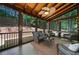 Comfortable screened porch with wood ceiling, ceiling fan, wicker furniture, and views of the backyard at 2009 Westside Ln, Woodstock, GA 30189