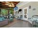 Relaxing screened porch with wood ceiling, wicker seating, mounted tv, and outdoor decor at 2009 Westside Ln, Woodstock, GA 30189