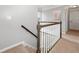 View of carpeted staircase with traditional wooden railing leading to the upper level at 2009 Westside Ln, Woodstock, GA 30189