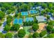 Aerial view of the community tennis courts, playground, and park nestled in a lush green setting at 2009 Westside Ln, Woodstock, GA 30189