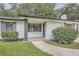 Inviting covered front porch with painted brick, lush bushes, and a manicured lawn at 2714 Preston Dr, Decatur, GA 30034