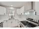 Bright kitchen with white cabinets, stainless steel appliances, and subway tile backsplash at 2714 Preston Dr, Decatur, GA 30034