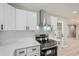 Modern kitchen featuring white cabinets, stainless steel appliances, and subway tile backsplash at 2714 Preston Dr, Decatur, GA 30034