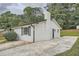 Rear view of brick home featuring an open, concrete patio and landscaped yard at 2714 Preston Dr, Decatur, GA 30034
