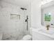 Beautifully updated bathroom with tiled shower, modern fixtures, and marble vanity at 5935 Christopher Ln, Lithonia, GA 30058