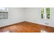 This bedroom has hardwood floors, windows and receives plenty of natural light at 5935 Christopher Ln, Lithonia, GA 30058