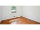 Bedroom with hardwood floors and a large window showcasing the outdoors at 5935 Christopher Ln, Lithonia, GA 30058