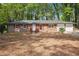 Charming single story brick home with red shutters and an attached two car garage at 5935 Christopher Ln, Lithonia, GA 30058