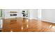 An open concept living space with an electric fireplace and hardwood floors leading to a remodeled kitchen at 5935 Christopher Ln, Lithonia, GA 30058