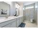 Modern bathroom featuring double vanity, a walk-in shower, and tile flooring at 6180 Misty Hill Ln, Buford, GA 30518