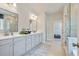 Modern bathroom with double vanity, tile floor, glass shower, and great lighting at 6180 Misty Hill Ln, Buford, GA 30518