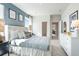 This bedroom has a white headboard, blue accent wall, carpeted floor and natural light from the window at 6180 Misty Hill Ln, Buford, GA 30518