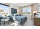 Bright bedroom featuring a large window, desk, football themed accents, and comfortable carpeted floor at 6180 Misty Hill Ln, Buford, GA 30518