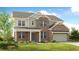 Charming two-story home with a brick facade, landscaped yard, and attached two-car garage at 6180 Misty Hill Ln, Buford, GA 30518