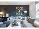 Comfortable living room with modern sofa, stylish decor, and rock and roll theme at 6180 Misty Hill Ln, Buford, GA 30518