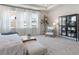 Bright primary bedroom with tray ceiling, large windows, and neutral color palette at 6180 Misty Hill Ln, Buford, GA 30518