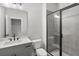 A stylish bathroom features a modern vanity with stone countertop and a glass enclosed shower at 171 Basil Street Dr, Cumming, GA 30040