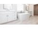 Modern bathroom featuring dual vanities, a freestanding tub, and a separate shower at 171 Basil Street Dr, Cumming, GA 30040