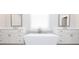 This bathroom features white double vanity sinks and a soaking tub with a faucet at 171 Basil Street Dr, Cumming, GA 30040