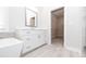 This bathroom features a vanity and a walk-in closet with shelving at 171 Basil Street Dr, Cumming, GA 30040