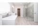 This bathroom features a soaking tub, glass shower, and modern tile work at 171 Basil Street Dr, Cumming, GA 30040