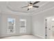 Bright bedroom featuring plush carpeting, a ceiling fan, and multiple windows for natural lighting at 171 Basil Street Dr, Cumming, GA 30040
