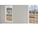 This bedroom features double-hung windows with views at 171 Basil Street Dr, Cumming, GA 30040