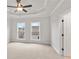 Comfortable carpeted bedroom with a ceiling fan and large windows offering natural light at 171 Basil Street Dr, Cumming, GA 30040