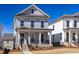 Charming two-story home with a covered front porch, neat landscaping, and classic architectural details at 171 Basil Street Dr, Cumming, GA 30040