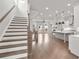 Open-concept interior with hardwood floors, staircase, and a modern kitchen island, perfect for entertaining at 171 Basil Street Dr, Cumming, GA 30040