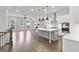 Modern kitchen featuring white cabinets, stainless steel appliances, a large island, and an open floor plan at 171 Basil Street Dr, Cumming, GA 30040