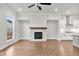 Cozy living room featuring a modern fireplace with a wooden mantle and a view of the backyard at 171 Basil Street Dr, Cumming, GA 30040