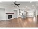 Open-concept living space connecting the kitchen, fireplace, and living area with abundant natural light at 171 Basil Street Dr, Cumming, GA 30040