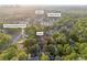 An aerial shot of Lilburn, GA, highlighting the home's location amidst lush greenery and the Yellow River at 2027 Kensington High Sw St, Lilburn, GA 30047
