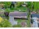 Aerial view of the property showcasing the home's layout, landscaping, driveway, and the surrounding neighborhood at 2027 Kensington High Sw St, Lilburn, GA 30047